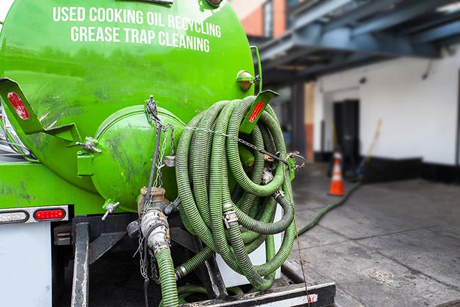 a pump truck emptying a grease trap in Arlington